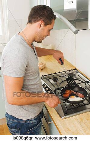 Man cooking fried breakfast View Large Photo Image Stock Photography - Man cooking fried breakfast. Fotosearch