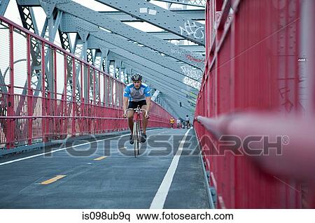 Man cycling over bridge View Large Photo Image Stock Photography - Man cycling over bridge. Fotosearch