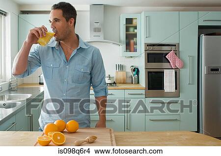 Picture - Man drinking orange juice. Fotosearch