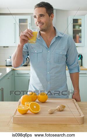 Stock Photograph - Man drinking orange juice. Fotosearch