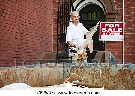 Man filling skip with rubble View Large Photo Image Stock Photo - Man filling skip with rubble. Fotosearch