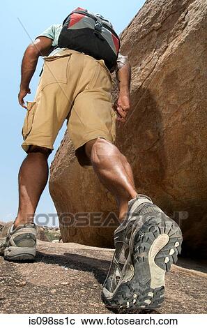Man hiking in rocky terrain View Large Photo Image Stock Image - Man hiking in rocky terrain. Fotosearch