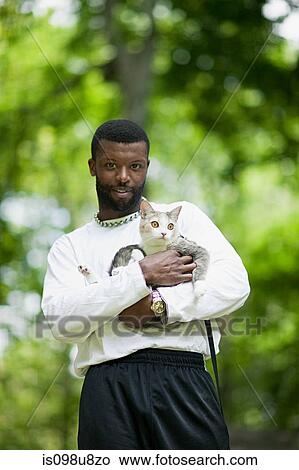 Picture - Man holding a cat. Fotosearch