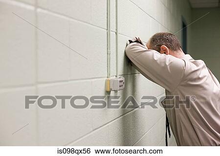 Stock Photograph - Man leaning on wall. Fotosearch