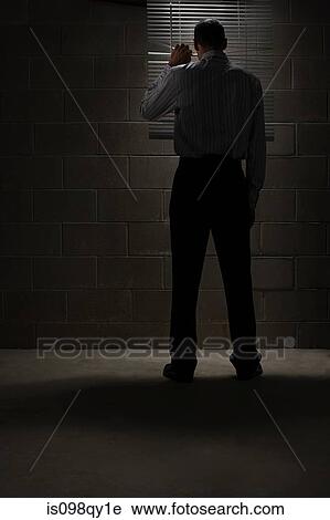 Man looking through blinds View Large Photo Image Stock Image - Man looking through blinds. Fotosearch
