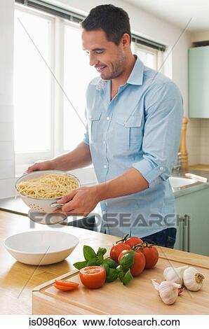 Man making meal View Large Photo Image Stock Photo - Man making meal. Fotosearch
