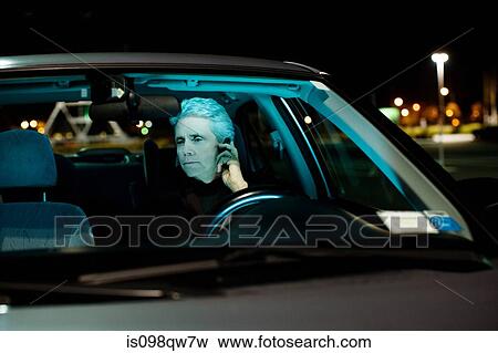 Stock Photo - Man on cellphone in car. Fotosearch