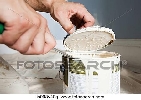 Stock Photography - Man opening paint tin. Fotosearch
