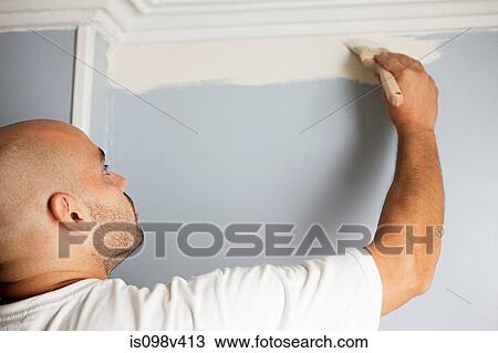 Stock Image - Man painting wall. Fotosearch