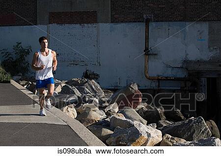 Man running in city View Large Photo Image Stock Image - Man running in city. Fotosearch