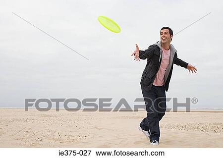 Man throwing a flying disc View Large Photo Image Stock Photo - Man throwing a flying disc. Fotosearch