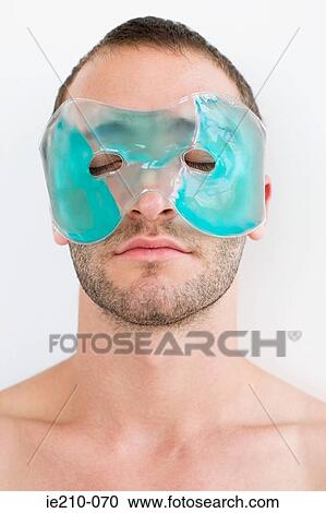 Stock Image - Man wearing gel mask. Fotosearch