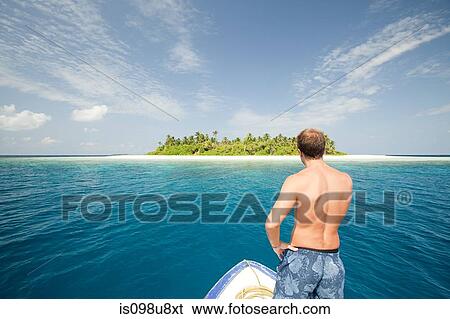 Man with boat, Baughagello Island, South Huvadhu Atoll, Maldives View Large Photo Image Stock Photograph - Man with boat, Baughagello Island, South Huvadhu Atoll, Maldives. Fotosearch