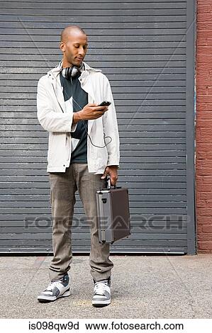 Man with cellphone and briefcase View Large Photo Image Stock Image - Man with cellphone and briefcase. Fotosearch