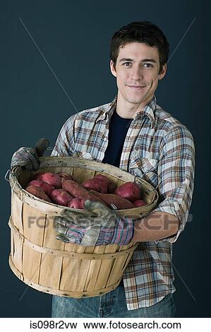 Man with container of potatoes View Large Photo Image Stock Photo - Man with container of potatoes. Fotosearch