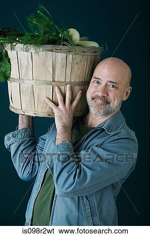 Stock Photograph - Man with container of vegetables. Fotosearch