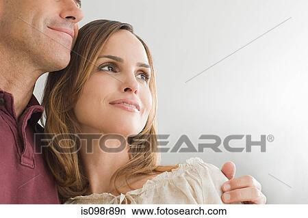 Man with his arm around his wife View Large Photo Image Picture - Man with his arm around his wife. Fotosearch