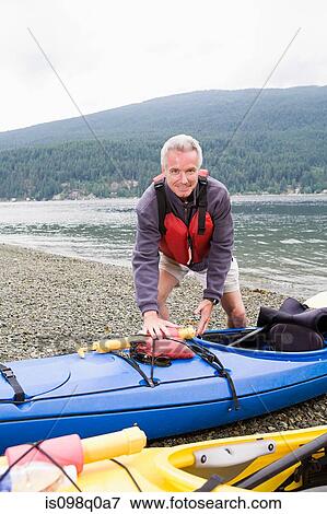 Stock Photo - Man with kayak. Fotosearch