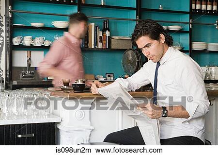 Man with newspaper and waiter in cafe View Large Photo Image Picture - Man with newspaper and waiter in cafe. Fotosearch