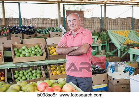 Market trader at fruit and vegetable stall View Large Photo Image Stock Photography - Market trader at fruit and vegetable stall. Fotosearch