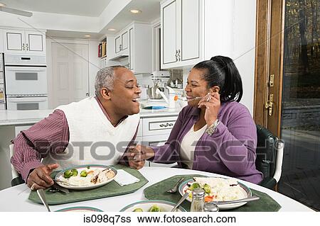 Stock Photograph - Mature couple enjoying a meal. Fotosearch
