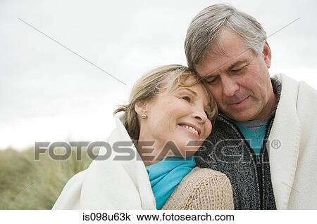 Mature couple outdoors, wrapped in blanket View Large Photo Image Stock Image - Mature couple outdoors, wrapped in blanket. Fotosearch