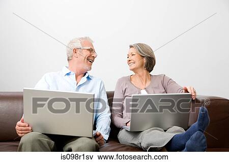 Stock Photo - Mature man and woman using a laptop. Fotosearch