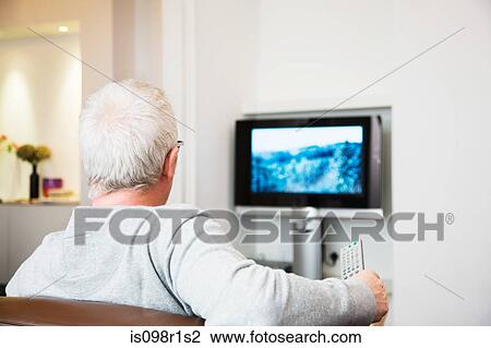Stock Image - Mature man watching television. Fotosearch