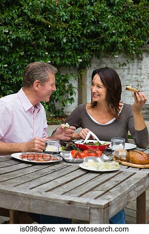 Mature woman and senior man dining al fresco View Large Photo Image Stock Image - Mature woman and senior man dining al fresco. Fotosearch