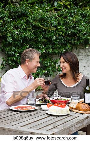 Mature woman and senior man dining al fresco View Large Photo Image Stock Photo - Mature woman and senior man dining al fresco. Fotosearch