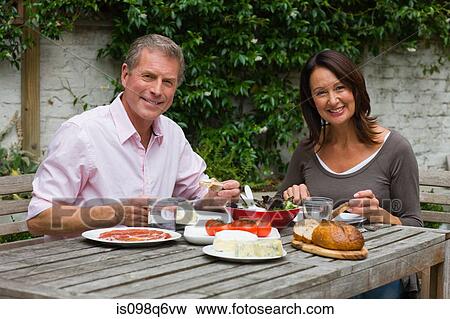 Mature woman and senior man dining al fresco View Large Photo Image Stock Photo - Mature woman and senior man dining al fresco. Fotosearch