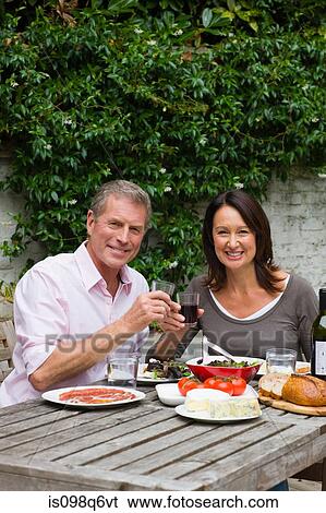Mature woman and senior man dining al fresco View Large Photo Image Stock Photograph - Mature woman and senior man dining al fresco. Fotosearch