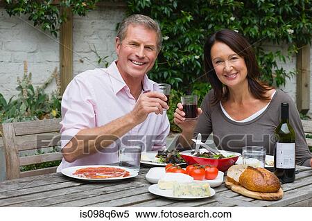 Mature woman and senior man dining al fresco View Large Photo Image Stock Photography - Mature woman and senior man dining al fresco. Fotosearch