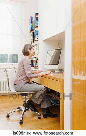 Mature woman using a computer View Large Photo Image Stock Photo - Mature woman using a computer. Fotosearch