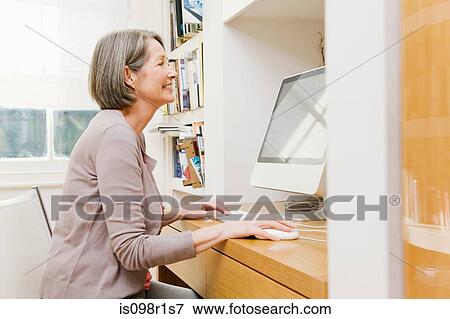 Stock Photo - Mature woman using a computer. Fotosearch