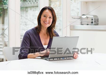 Stock Photo - Mature woman using a laptop. Fotosearch