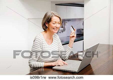Mature woman using internet banking View Large Photo Image Stock Photo - Mature woman using internet banking. Fotosearch