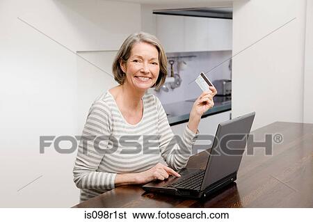Mature woman using internet banking View Large Photo Image Stock Photograph - Mature woman using internet banking. Fotosearch
