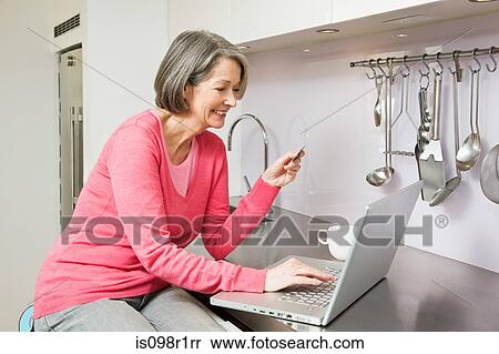 Mature woman using internet banking View Large Photo Image Stock Photography - Mature woman using internet banking. Fotosearch