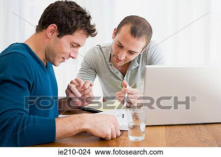 Picture - Men doing finances. Fotosearch