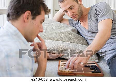 Stock Photo - Men playing backgammon. Fotosearch