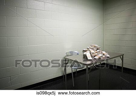 Stock Image - Money on table in interview room. Fotosearch