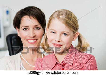 Stock Image - Mother and daughter at dentists office. Fotosearch