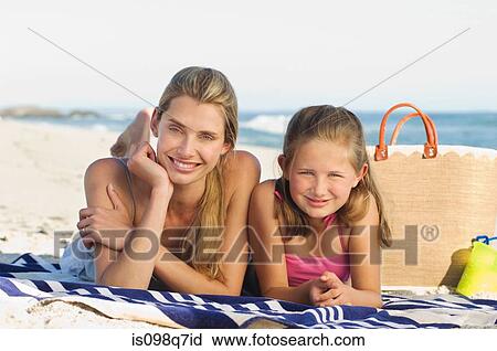 Stock Image - Mother and daughter at the beach. Fotosearch