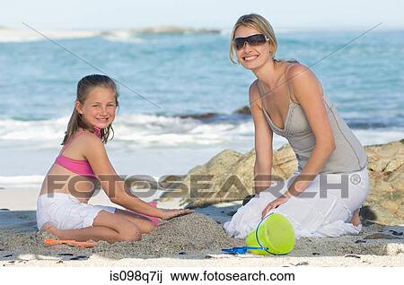 Stock Image - Mother and daughter at the beach. Fotosearch