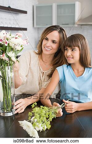 Mother and daughter flower arranging View Large Photo Image Stock Image - Mother and daughter flower arranging. Fotosearch