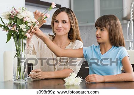 Stock Photo - Mother and daughter flower arranging. Fotosearch