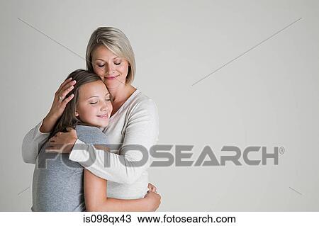 Mother and daughter hugging View Large Photo Image Stock Image - Mother and daughter hugging. Fotosearch