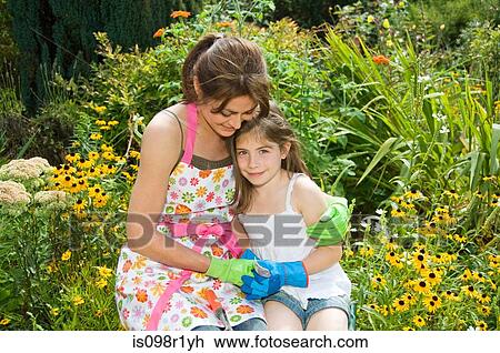 Mother and daughter in garden View Large Photo Image Stock Image - Mother and daughter in garden. Fotosearch