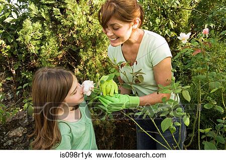 Mother and daughter in garden View Large Photo Image Stock Image - Mother and daughter in garden. Fotosearch